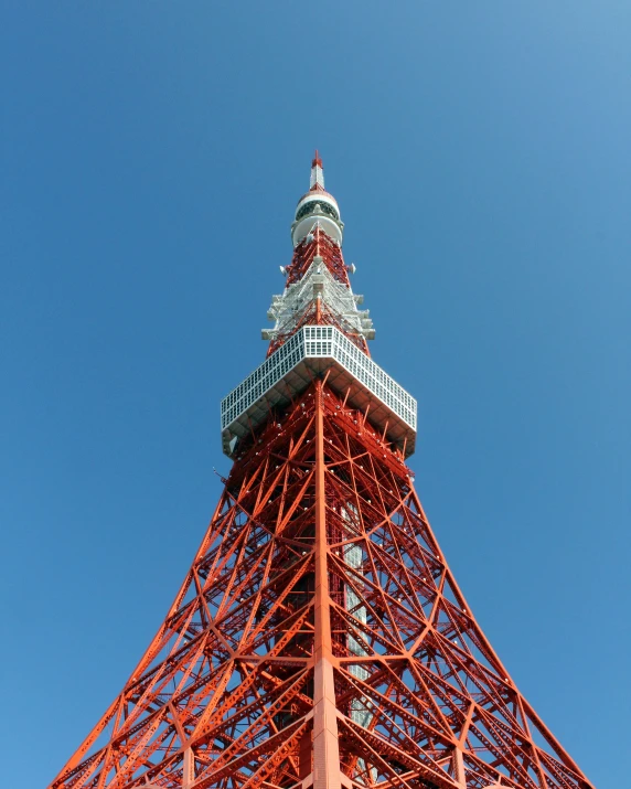 an orange eiffel tower against a blue sky