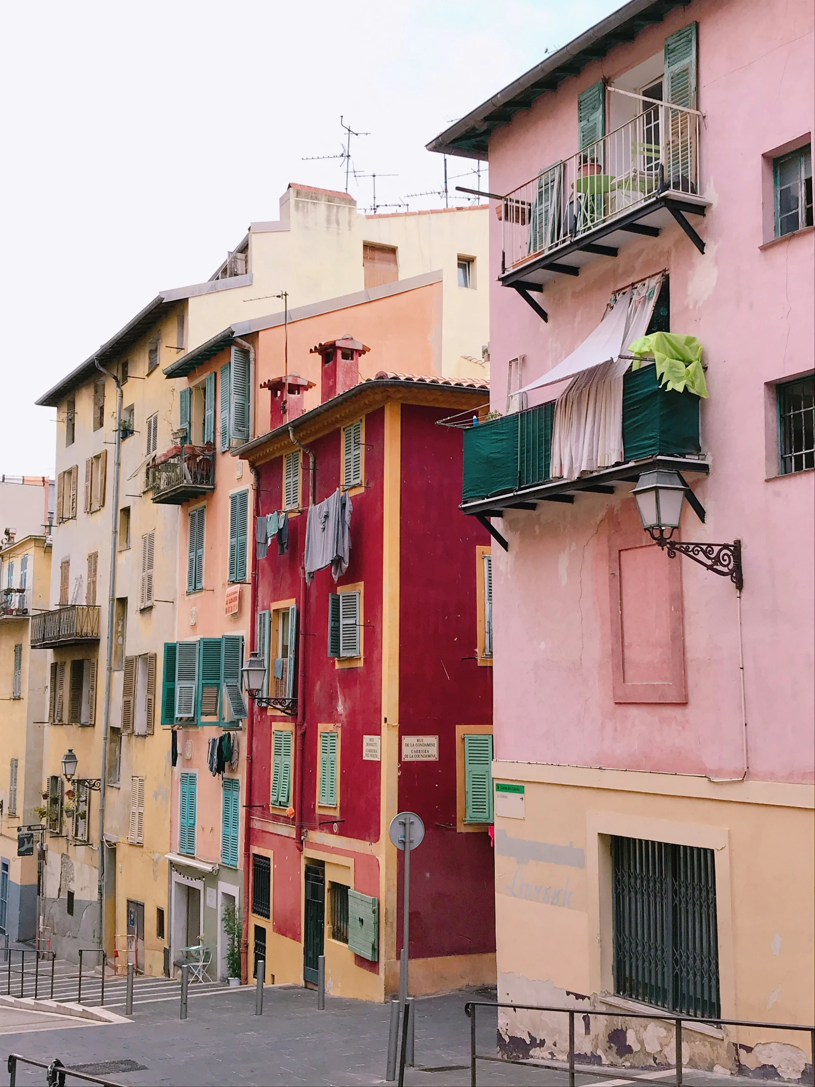 several buildings painted different colors with windows on each side