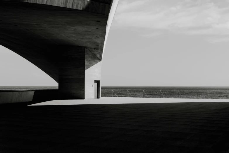 a person stands on the concrete next to the water