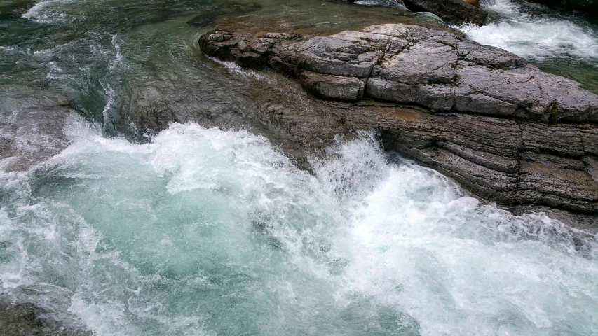 some rocks and water with small waves in the river