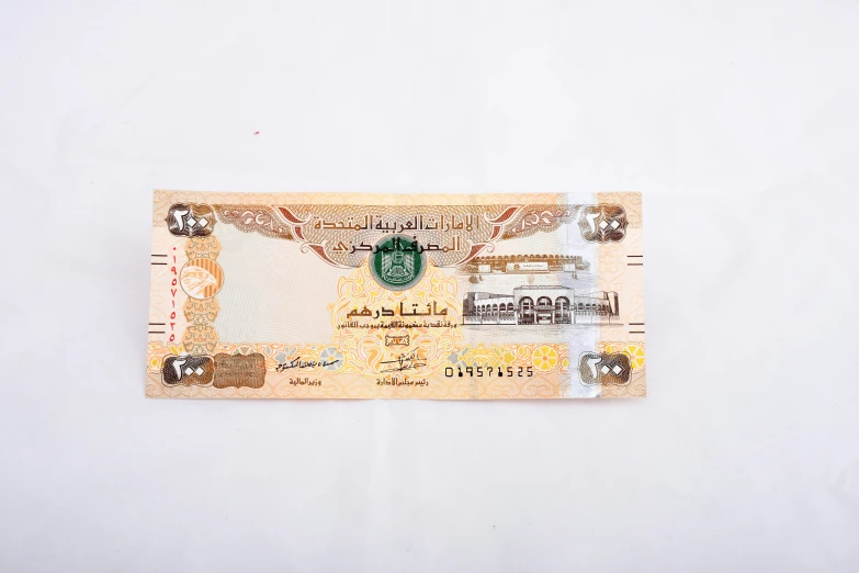 a piece of currency with green and white designs