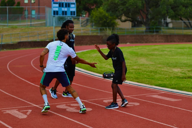 two people on a race track giving each other hands