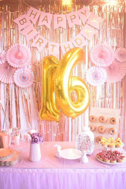 a birthday party table filled with food and balloons
