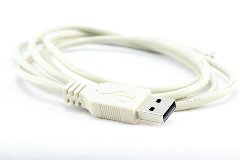 a white usb cable laying on its side