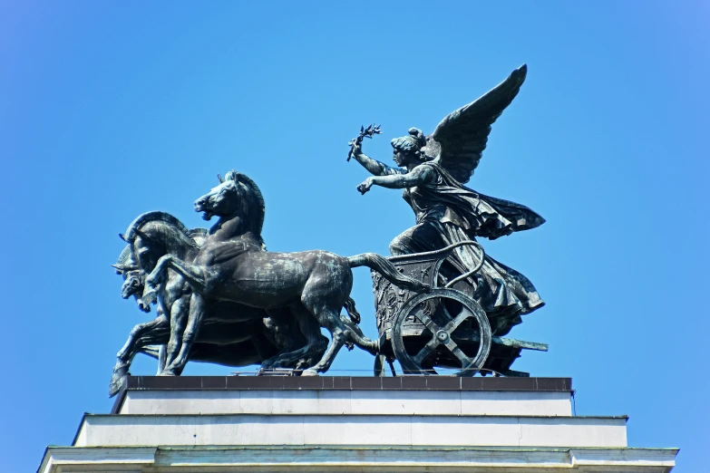 a statue on top of a horse with an angel flying overhead
