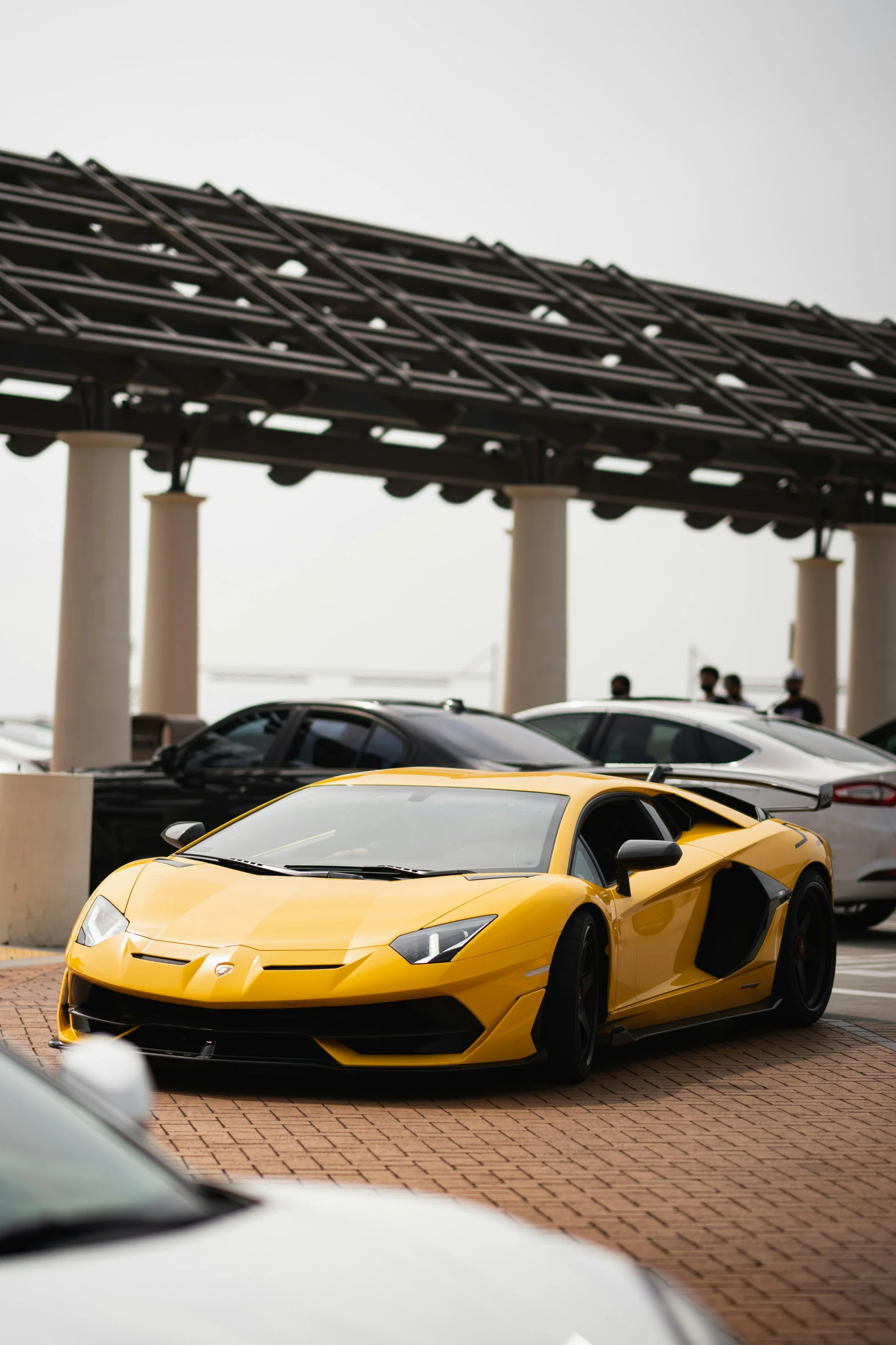 several sports cars parked in a parking lot