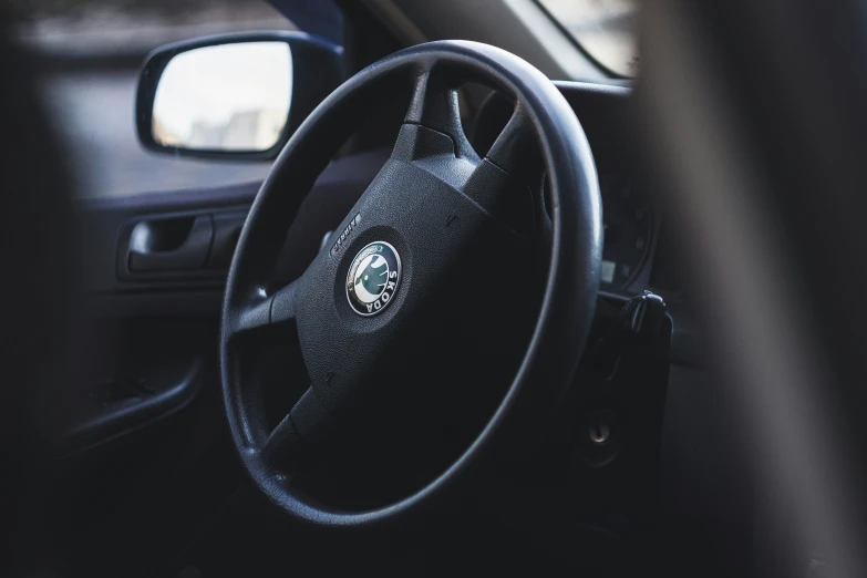 a steering wheel in a black car with black interior