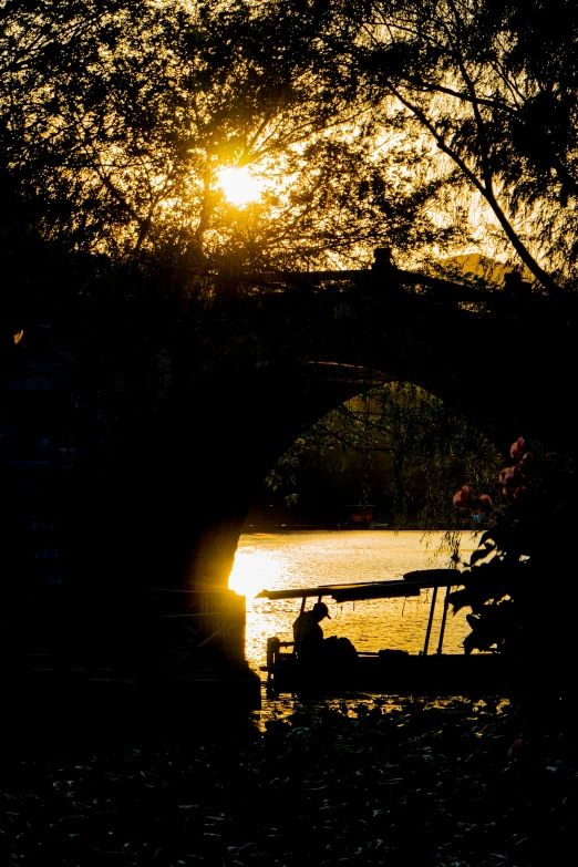 there is a boat that is on the water at sunset