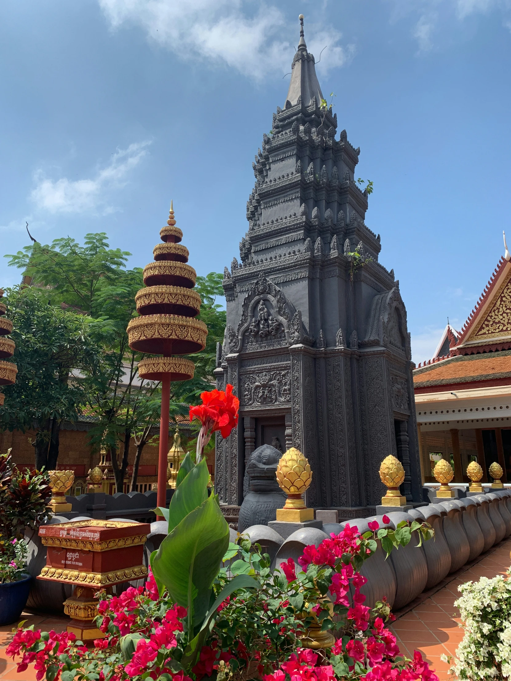 flowers are in front of a very pretty statue