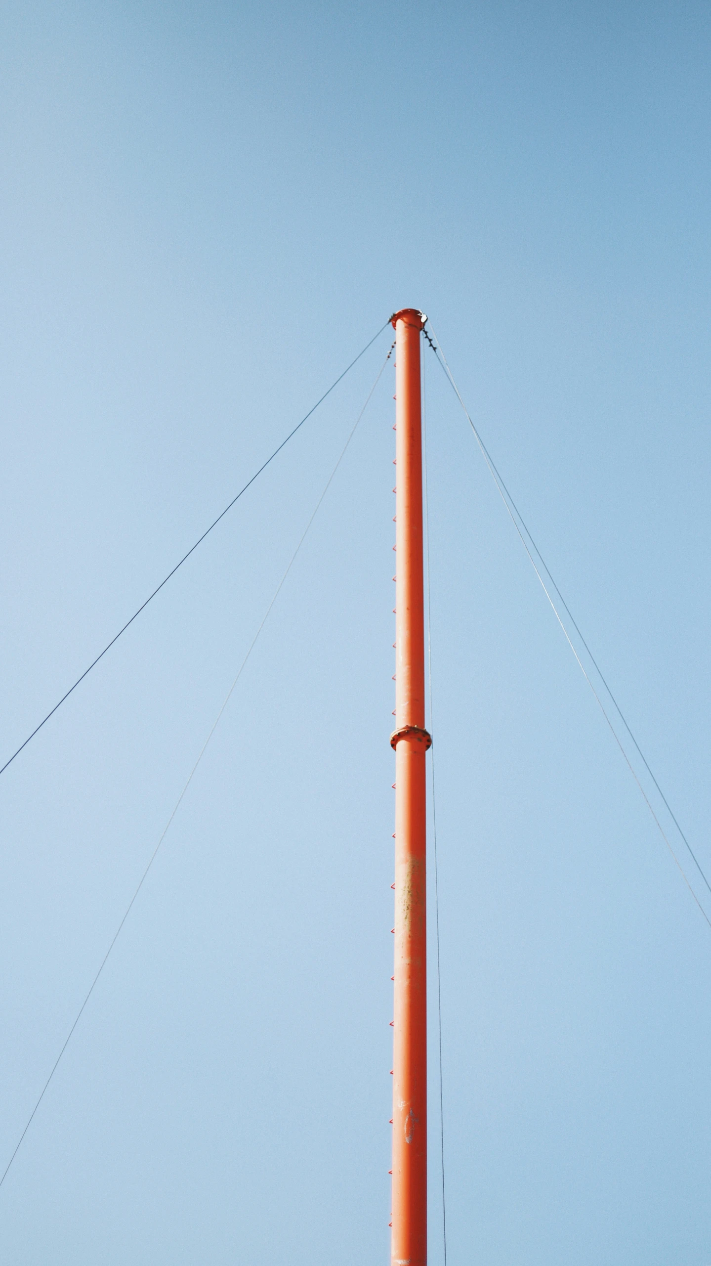 the back side of a pole with a bird perched on top of it