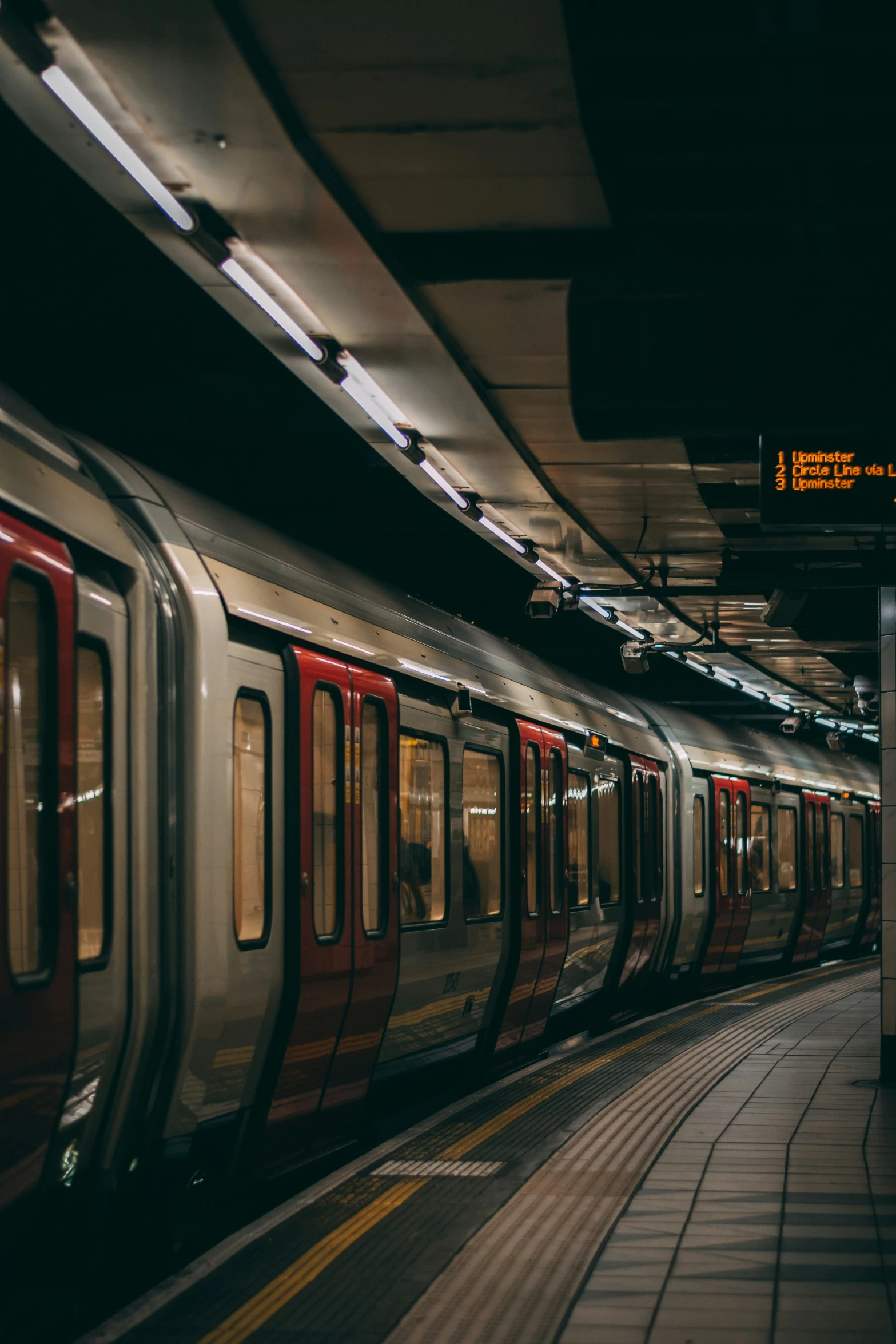 the metro train is approaching the platform at night