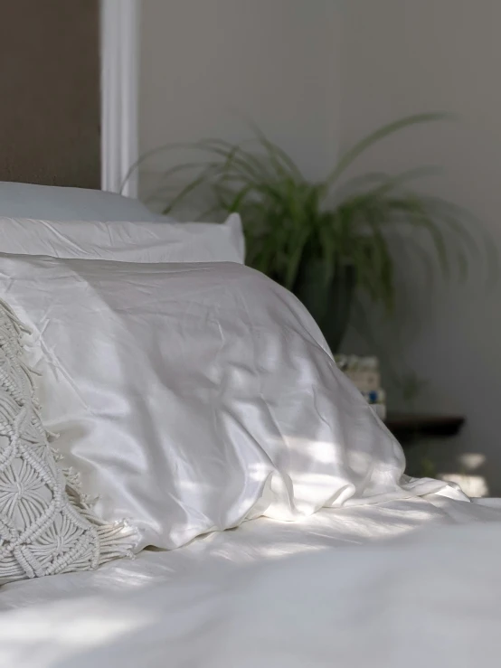 a close up of a bed with some pillows on it