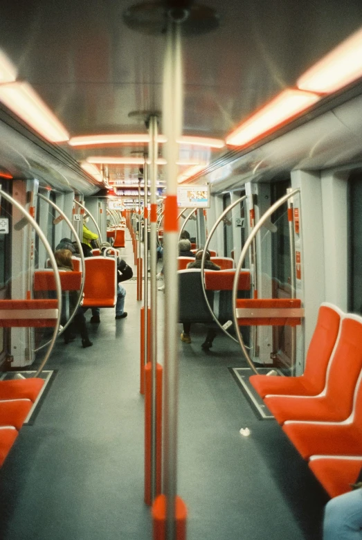 this is an empty metro car, with orange seats