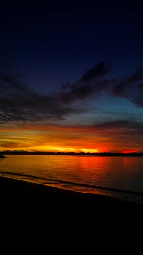 a sunset view from the beach at the end of the day