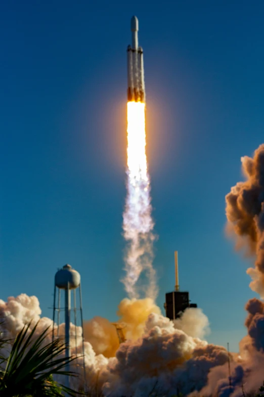 a rocket is launching into the sky with smoke coming from it