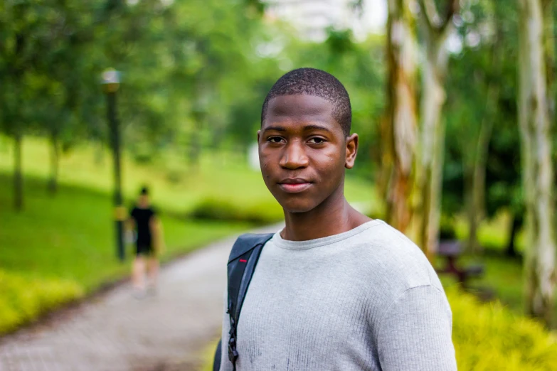 a man walking down a road wearing a backpack