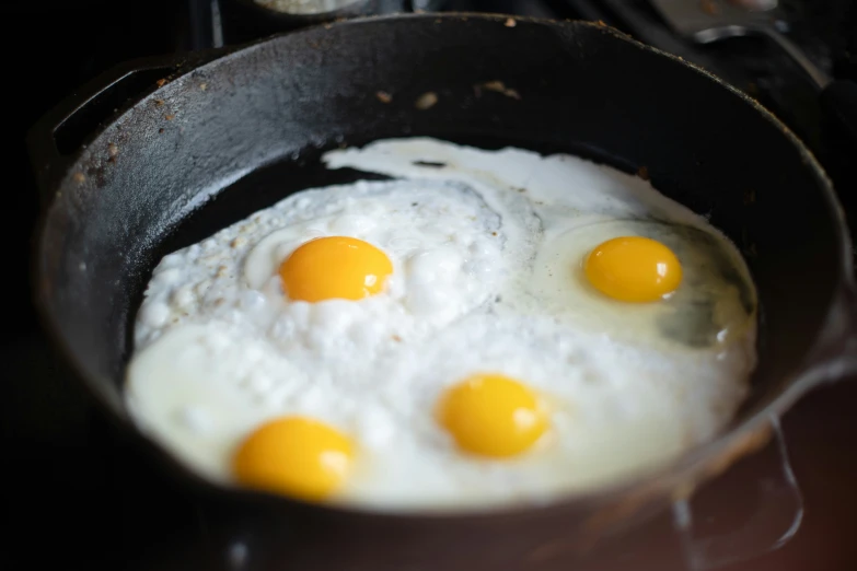 eggs in a pan that are frying on the stove