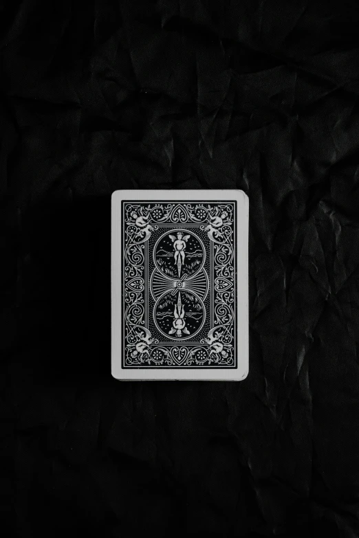 a black and white playing card, that has a double deck on top