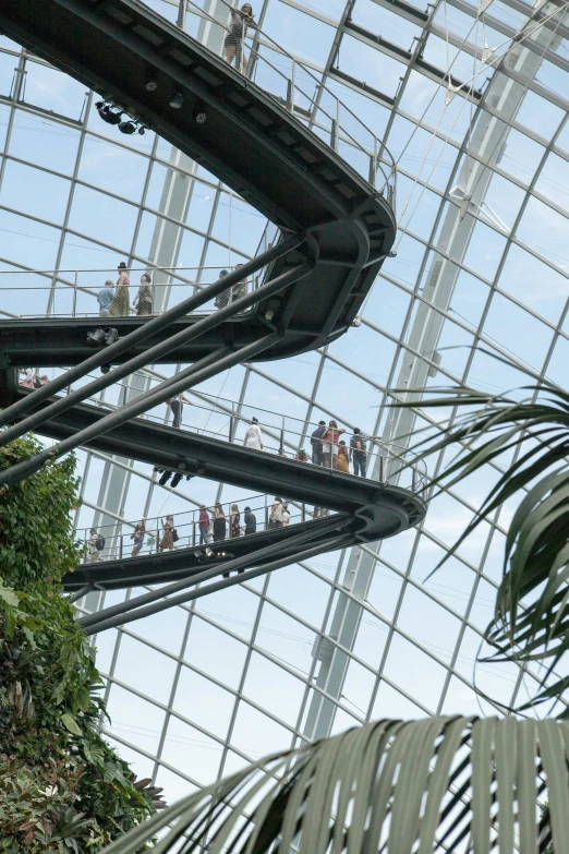 some people are walking around an indoor waterfall