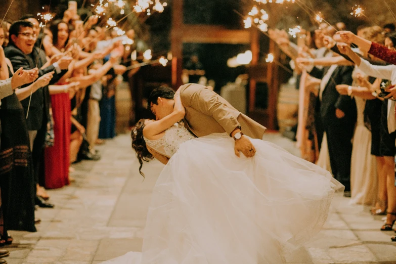 a woman is standing outside with her wedding dress