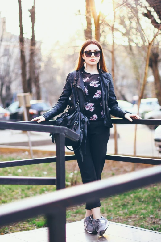 woman posing for a picture with her arms crossed outside