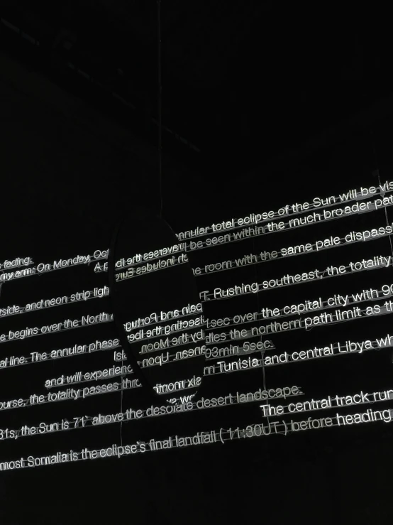 the back wall of an apple store illuminated with text