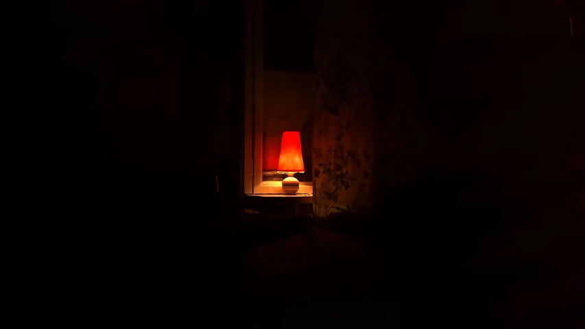 the lamp is lit in the dark room