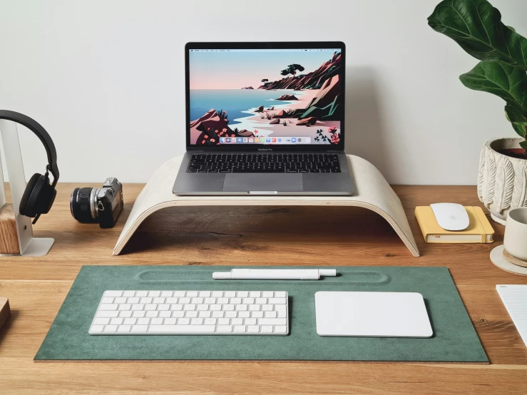 a laptop is on a table with headphones