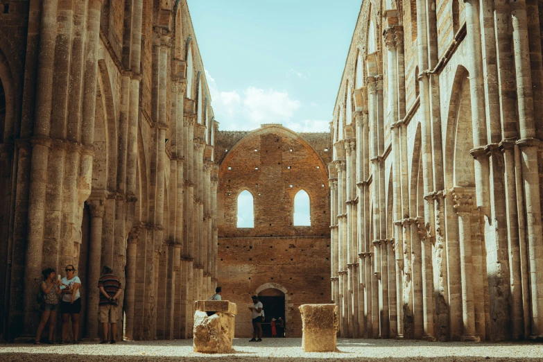 men sit at a stone structure inside the ruins