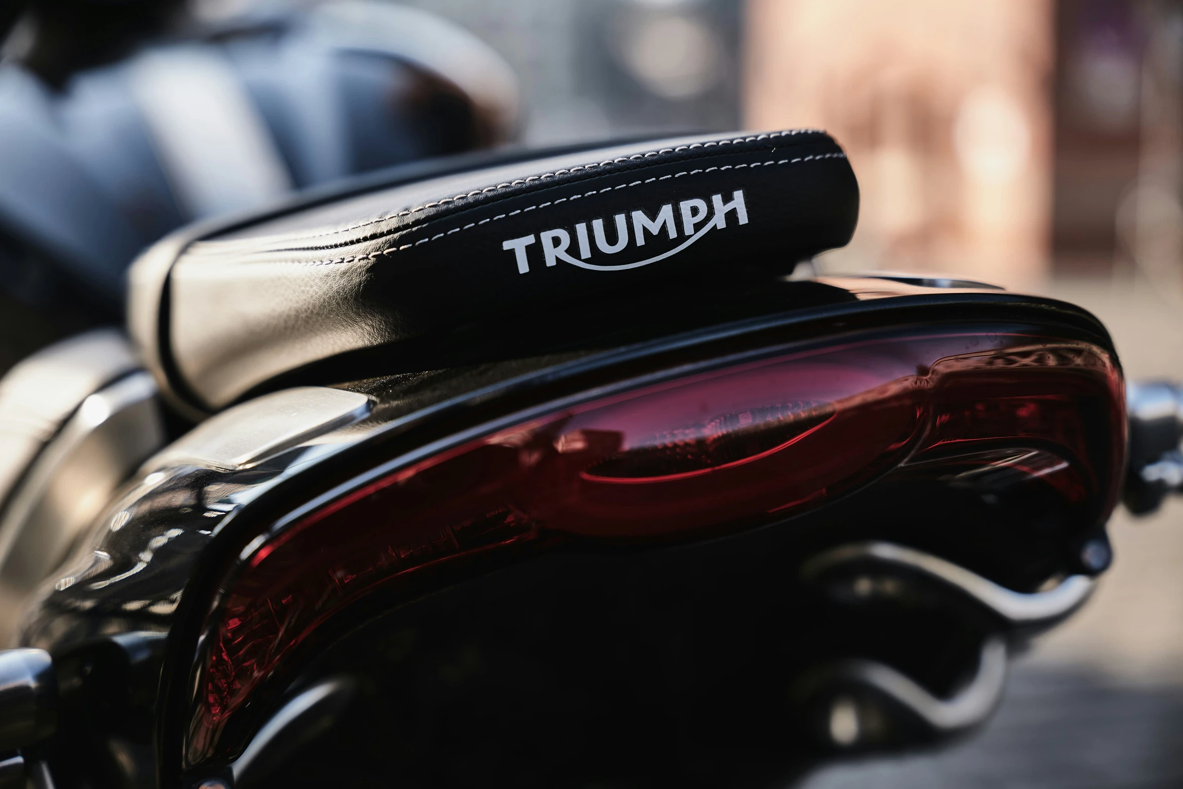 a close - up of the trunk and seat lid of a triumph motorcycle