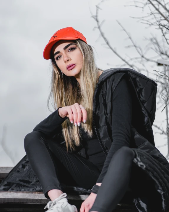 a woman with long hair sitting on a bench