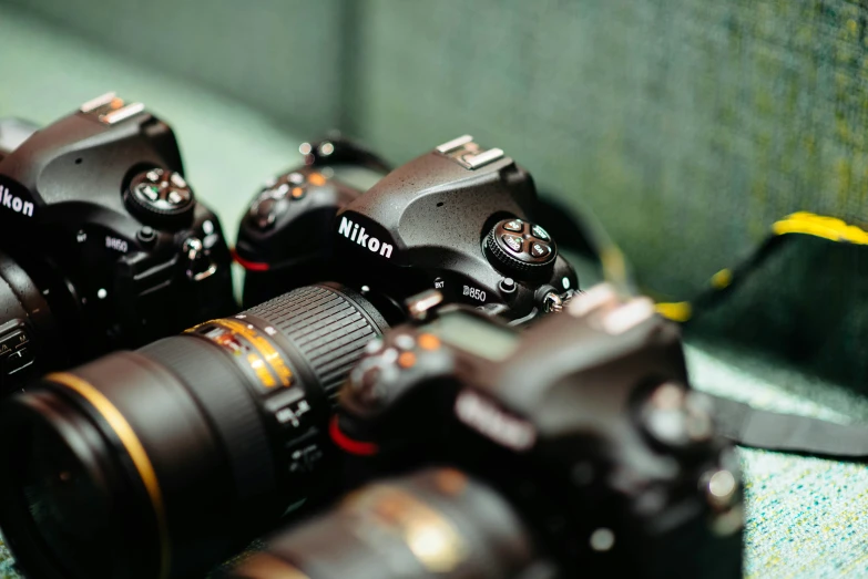 a close up of four cameras with their lens caps on