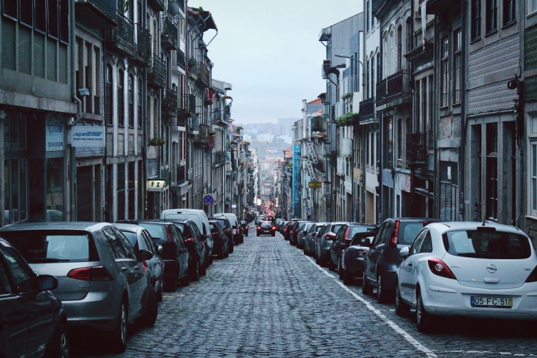 a city street with parked cars on both sides