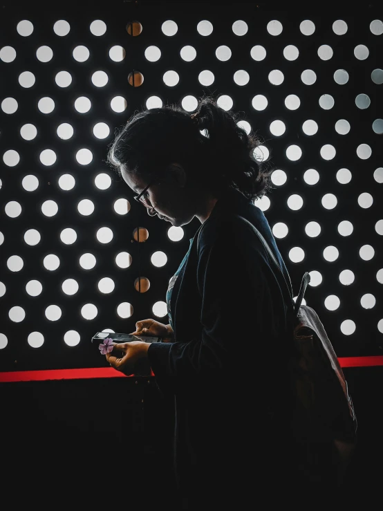 a woman with dark hair texting on her phone