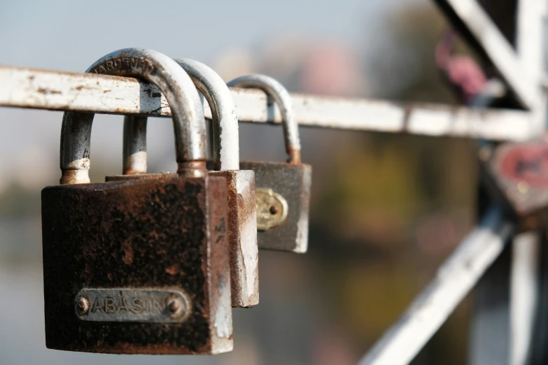 two padlocks attached to a fence with the word'we're here written on them