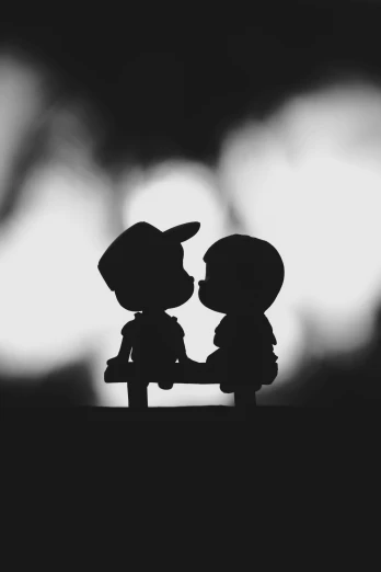 the silhouettes of a couple holding hands are black and white