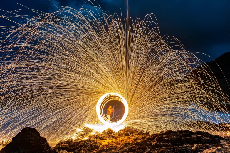 a large circular structure of light that looks like it is spinning on fire