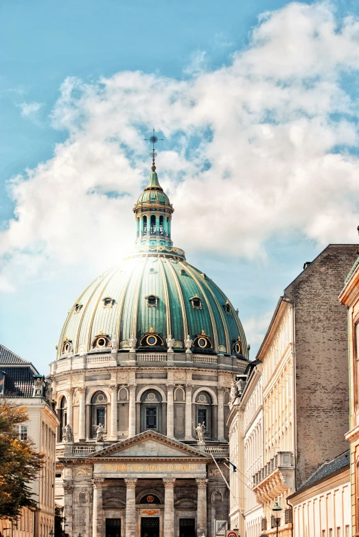 a cathedral tower with a dome and green roof