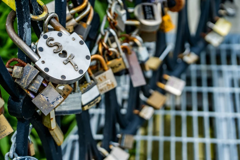 a bunch of padlocks that have been placed on a fence