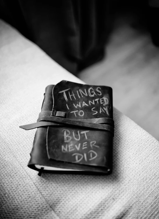 a black and white po of writing on a book with a knife