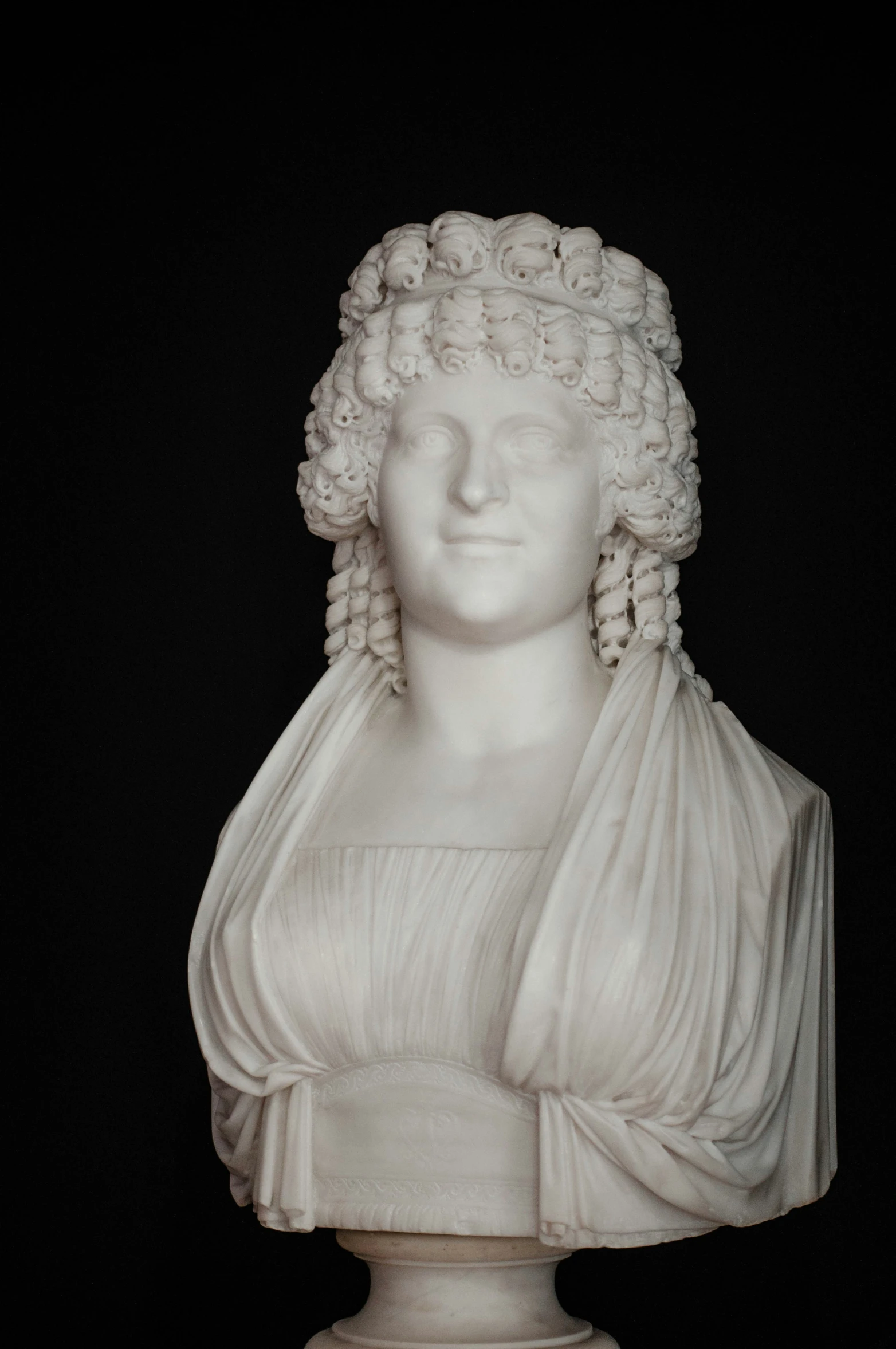 a white sculpture has hair on its head