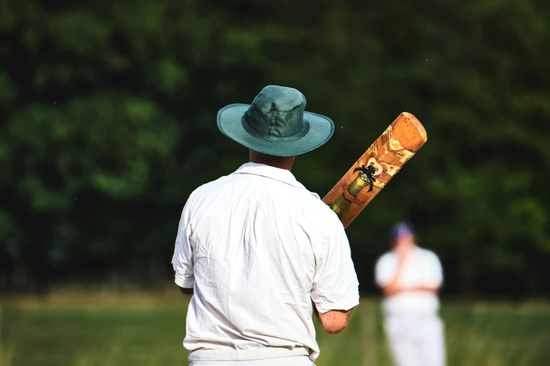 a man wearing a hat holding a piece of bread