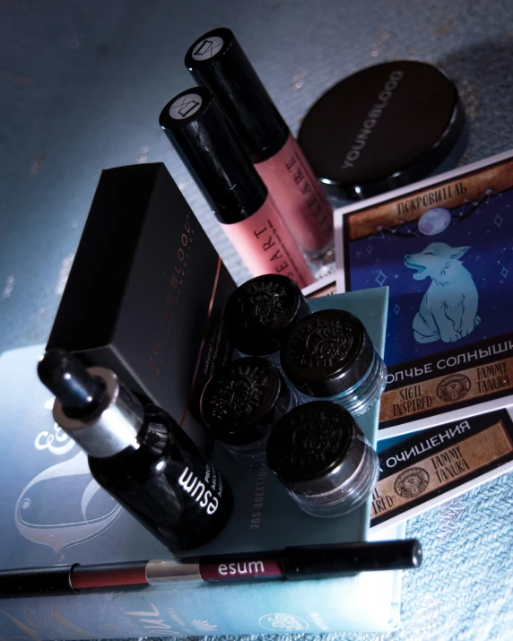 cosmetics on a table with a silver case