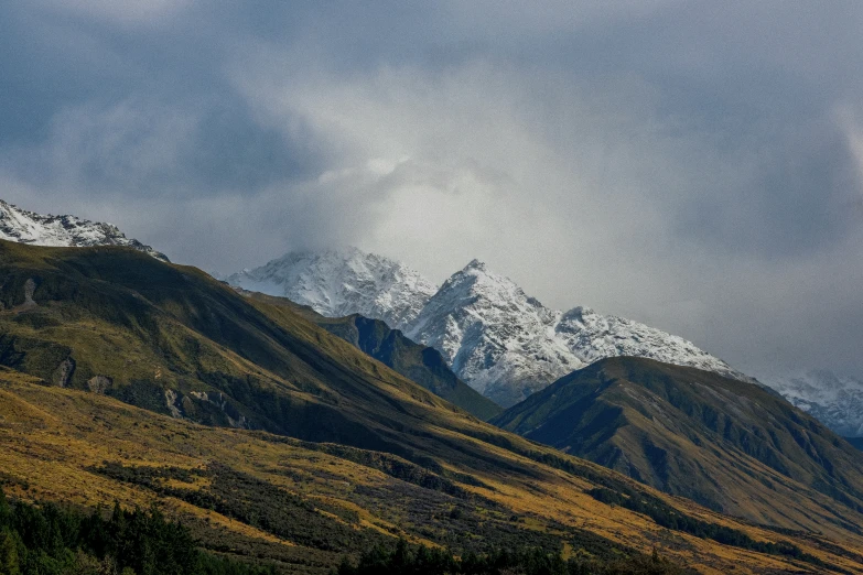 a mountain that is surrounded by snow and green