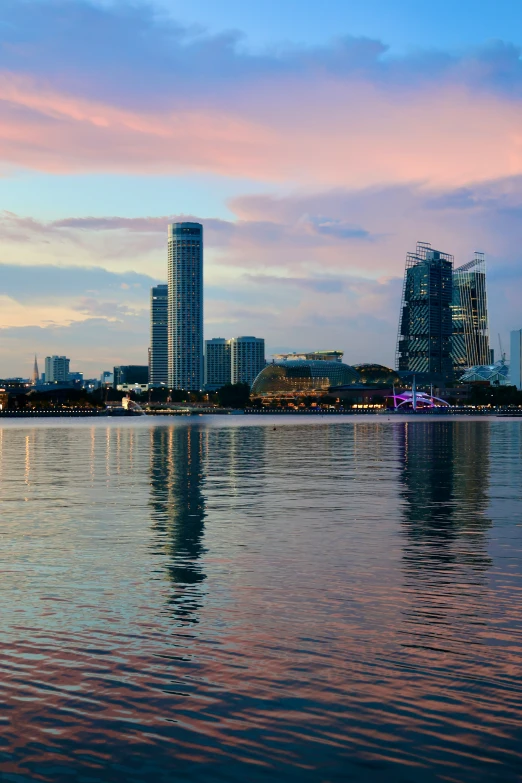 a big lake in front of some tall buildings