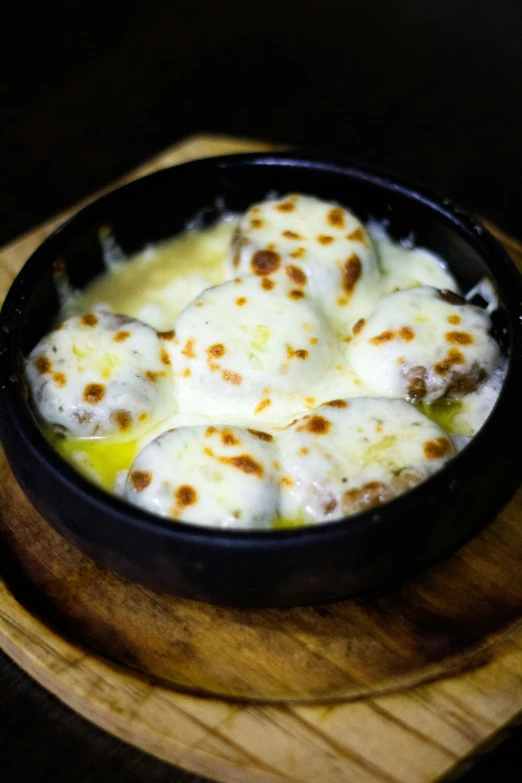 a black pan with white eggs in it on top of a table