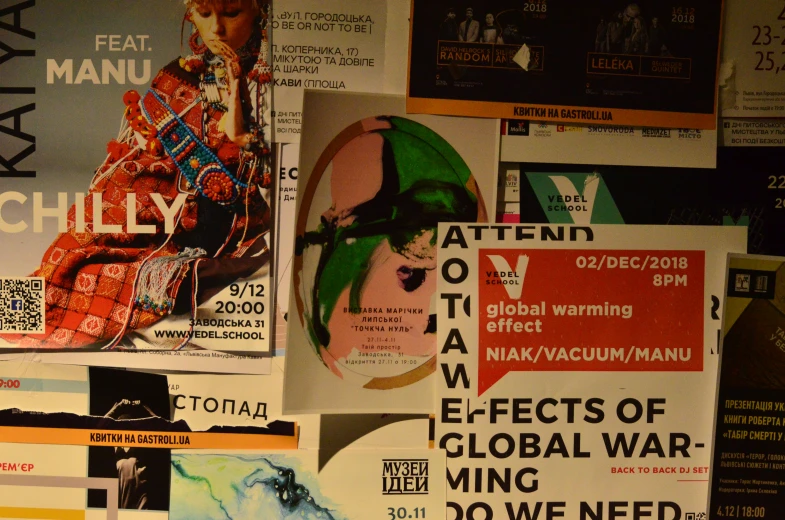 various posters on the wall with a person on the one