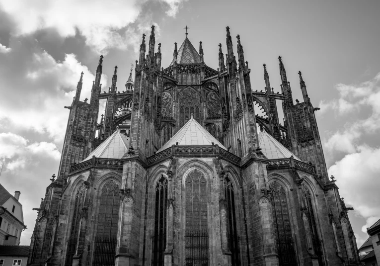 a gothic cathedral with two spires against the cloudy sky