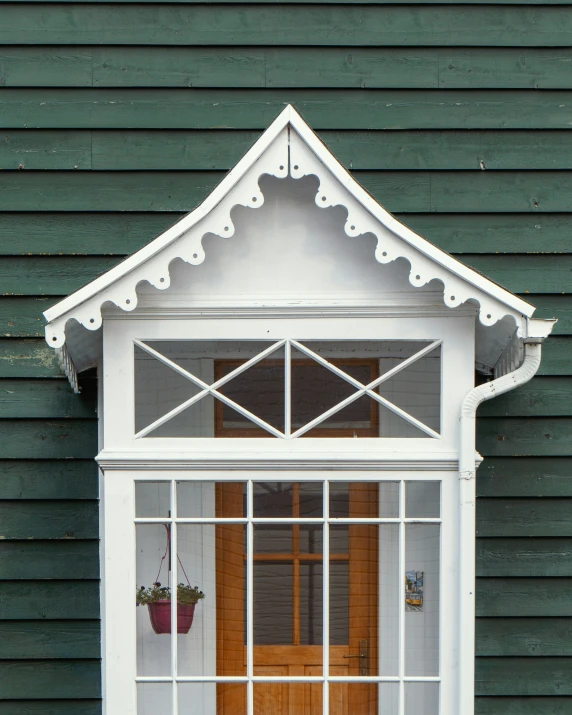 a window with wooden door and green wall