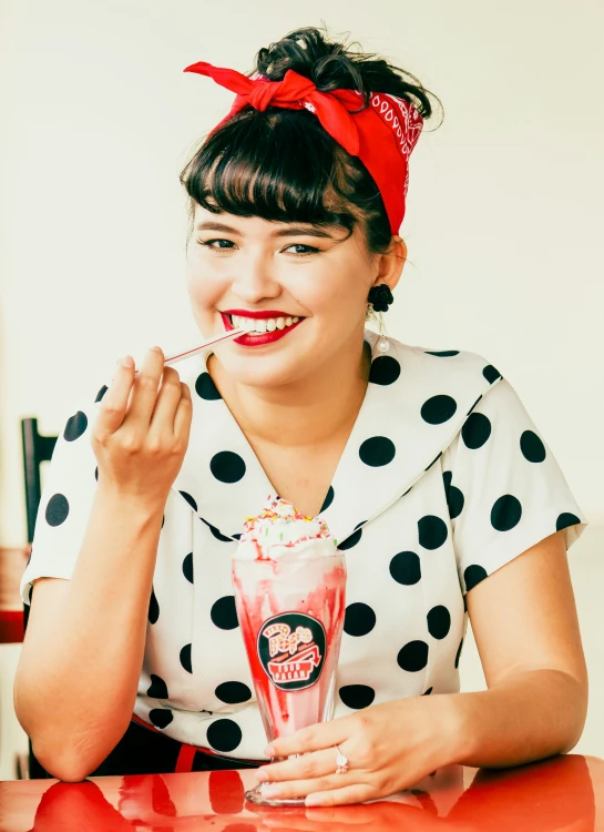 a lady posing with a candy - bar on her lip